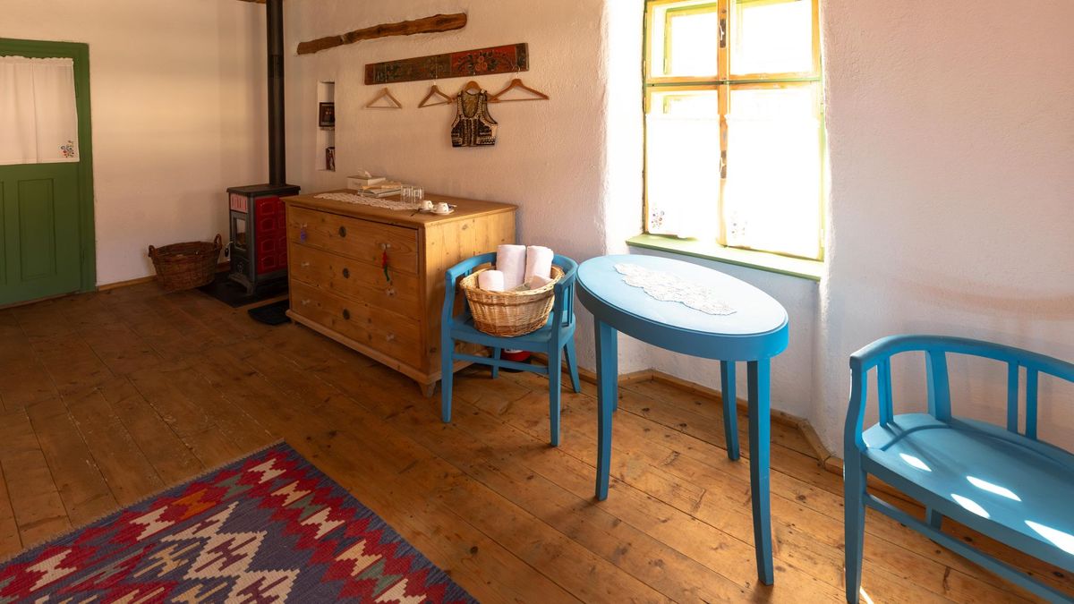 Old Saxon chest of drawers under the painted coat rack