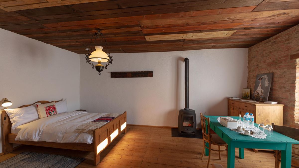 Double bed beside the Invicta cast-iron stove