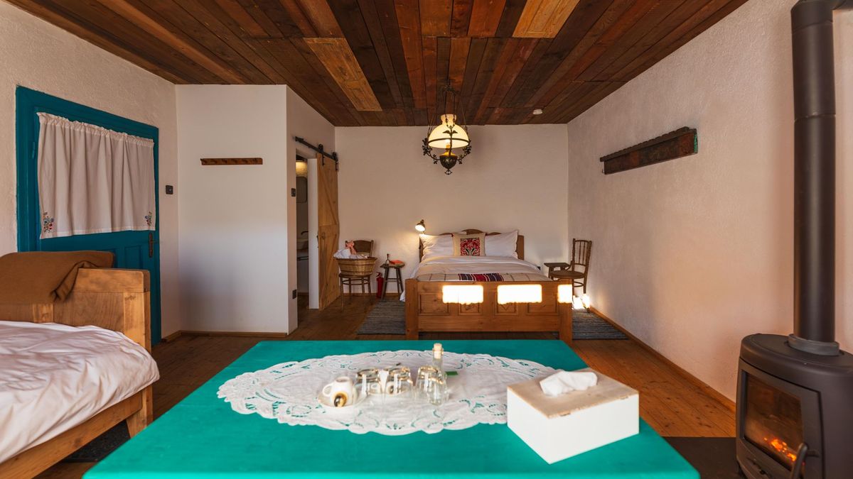 Green table with a lace runner, the stove glowing behind it
