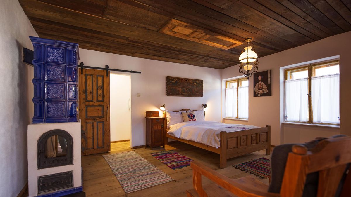 Cobalt tile stove beside the double bed
