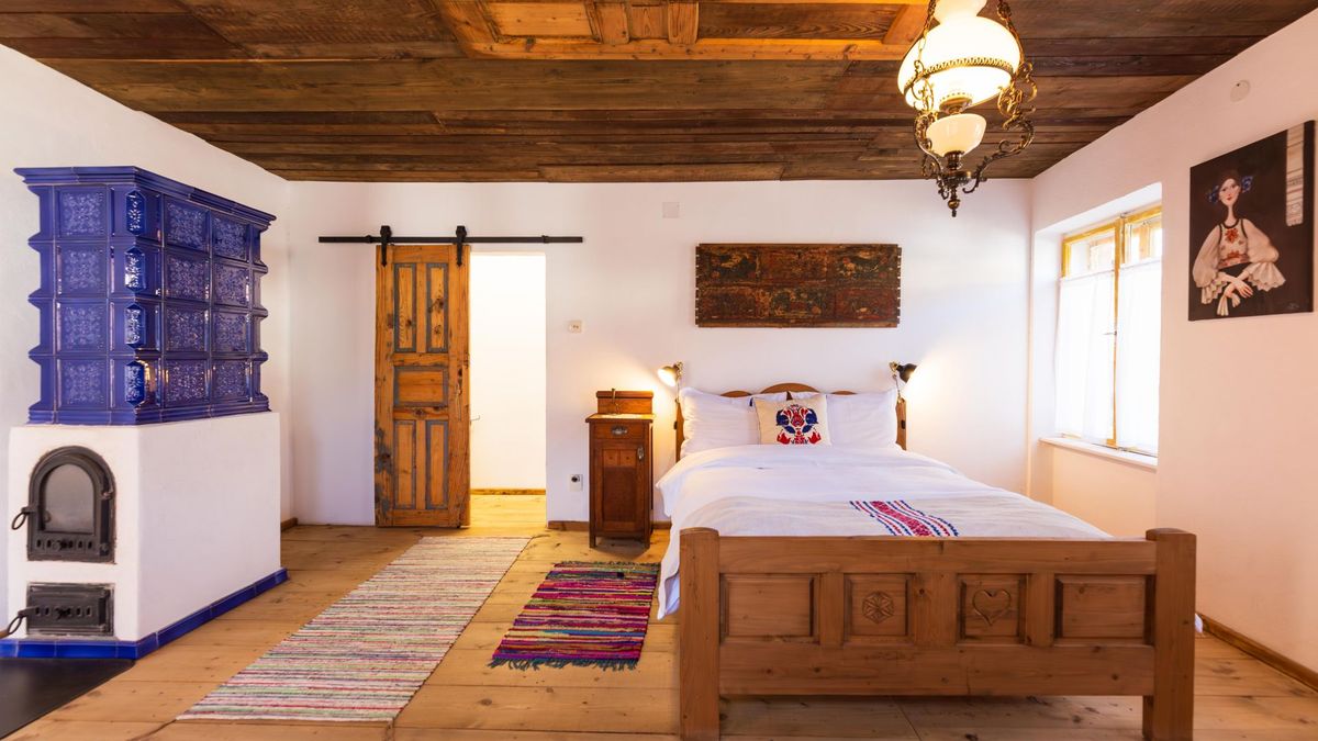 The room with its cobalt stove, carved bed and sliding plank door