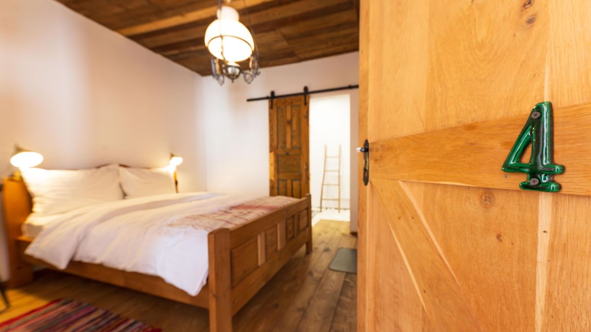 Bed beside the oak door with the number 4