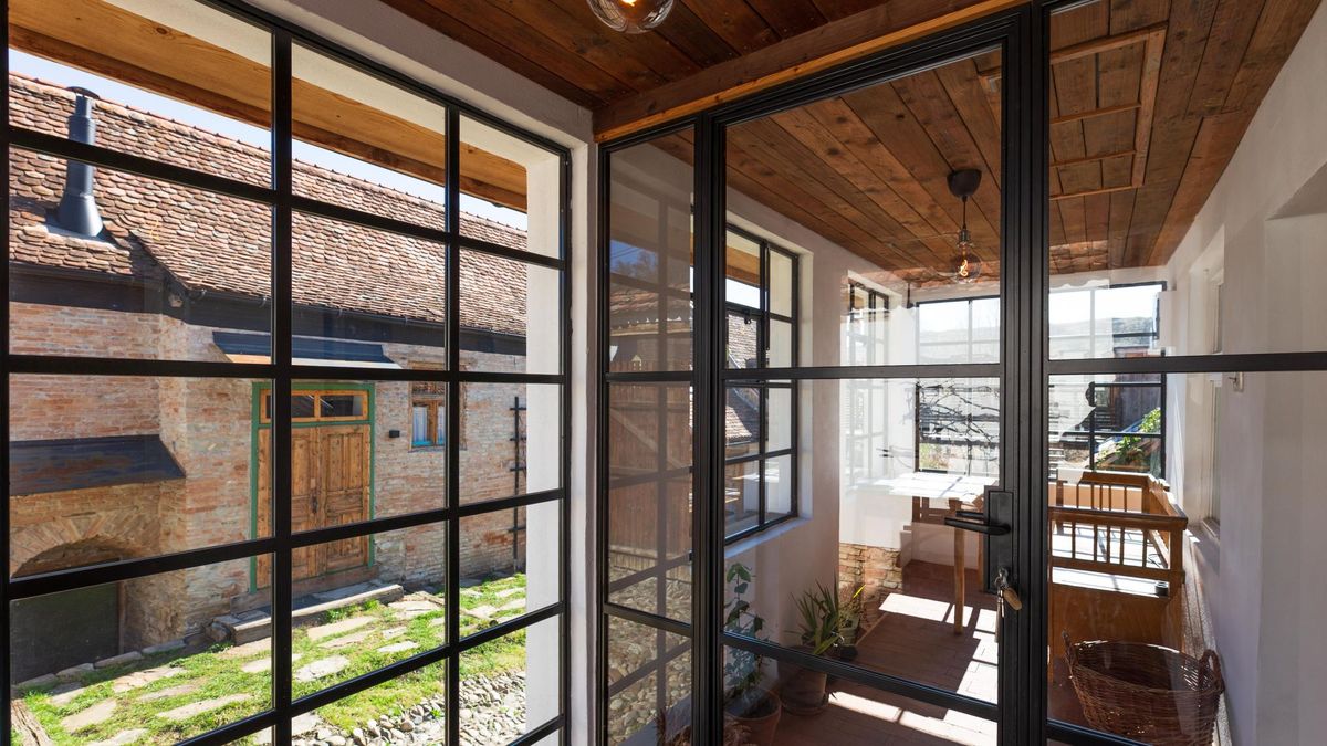 The glazed balcony, looking down onto the courtyard and the old roofs