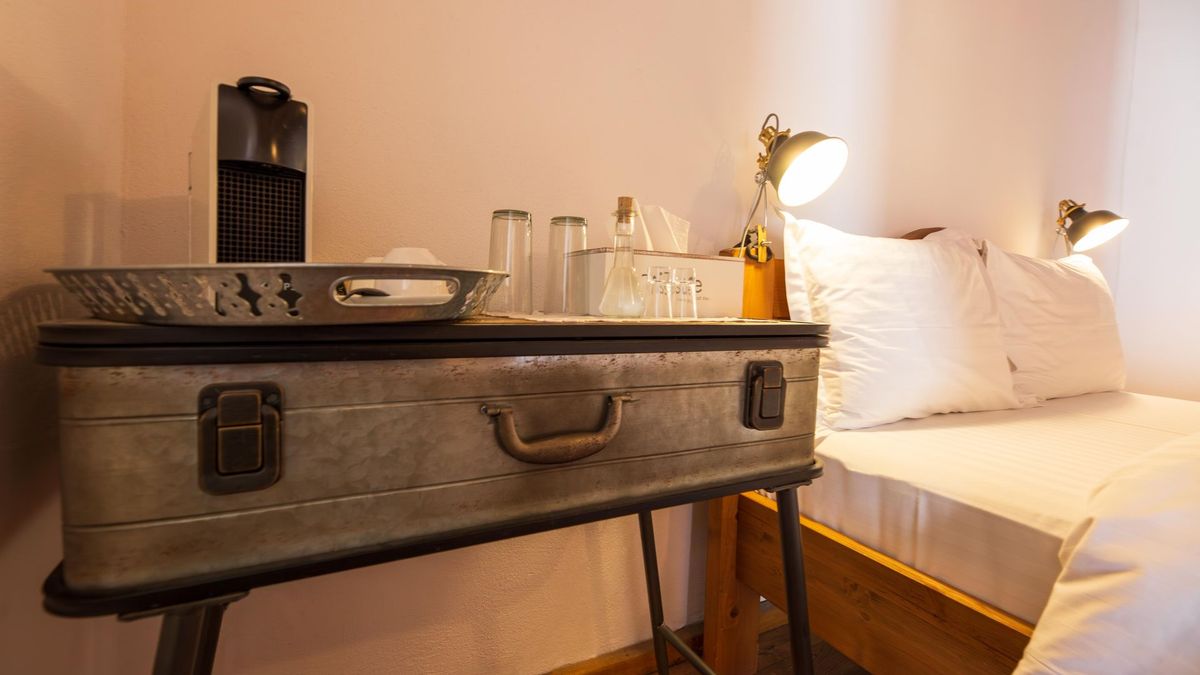 An old suitcase as a bedside table, with the Nespresso machine